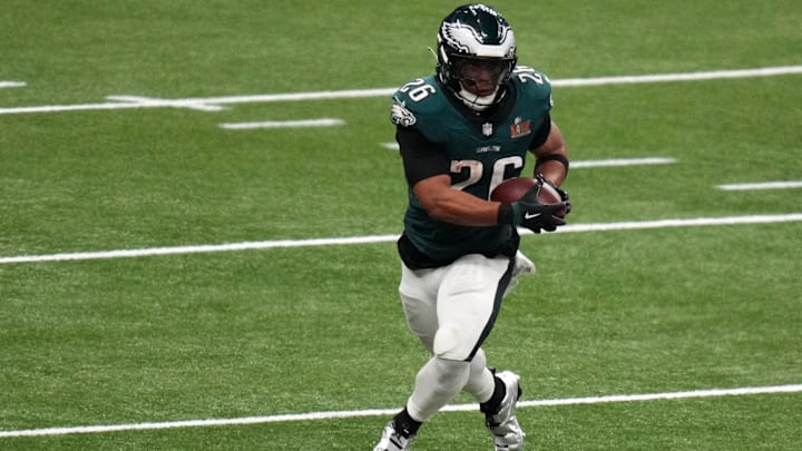 Feb 9, 2025; New Orleans, LA, USA; Philadelphia Eagles running back Saquon Barkley (26) rushes the ball against the Kansas City Chiefs during the fourth quarter in Super Bowl LIX halftime show at Caesars Superdome.  
