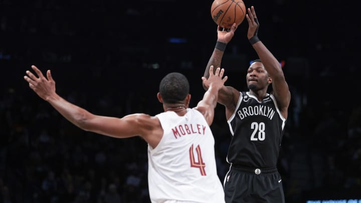 Mar 21, 2023; Brooklyn, New York, USA; Brooklyn Nets forward Dorian Finney-Smith (28) shoots the ball against Cleveland Cavaliers forward Evan Mobley (4) during the second half at Barclays Center. Mandatory Credit: Vincent Carchietta-USA TODAY Sports