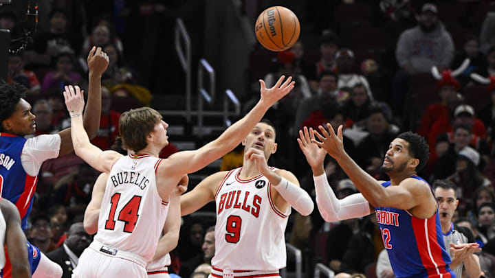 Feb 12, 2025; Chicago, Illinois, USA;  Chicago Bulls forward Matas Buzelis (14) and center Nikola Vucevic (9) chase the ball against Detroit Pistons forward Tobias Harris (12) during the first half at the United Center. Mandatory Credit: Matt Marton-Imagn Images