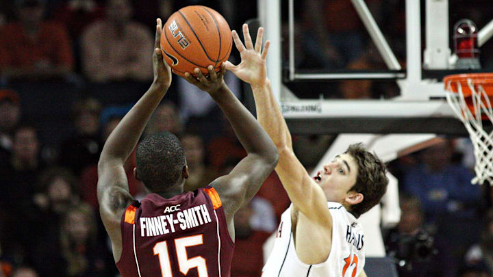 Jan 22, 2012; Charlottesville, VA, USA; Virginia Tech Hokies forward Dorian Finney-Smith (15) shoots over Virginia Cavaliers guard Joe Harris (12) at the John Paul Jones Arena. Mandatory Credit: Peter Casey-Imagn Images