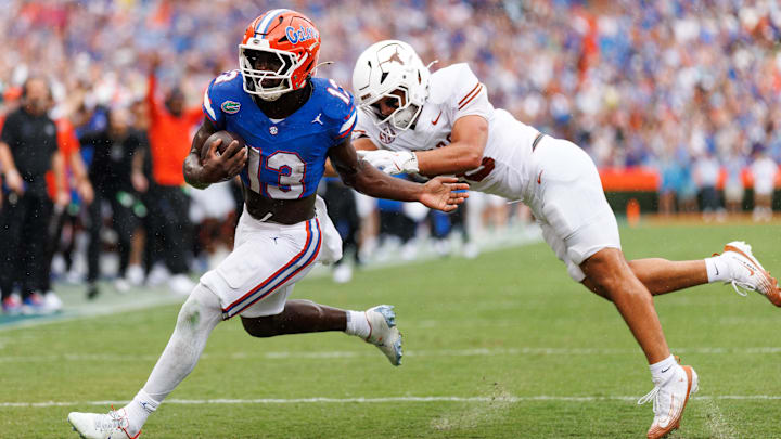 Oct 4, 2025; Gainesville, Florida, USA; Florida Gators running back Jadan Baugh (13) breaks a tackle from Texas Longhorns linebacker Liona Lefau (18) during the first half at Ben Hill Griffin Stadium. Mandatory Credit: Matt Pendleton-Imagn Images