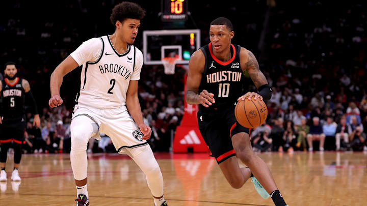 Jan 3, 2024; Houston, Texas, USA; Houston Rockets forward Jabari Smith Jr. (10) handles the ball against Brooklyn Nets forward Cameron Johnson (2) during the third quarter at Toyota Center. Mandatory Credit: Erik Williams-Imagn Images