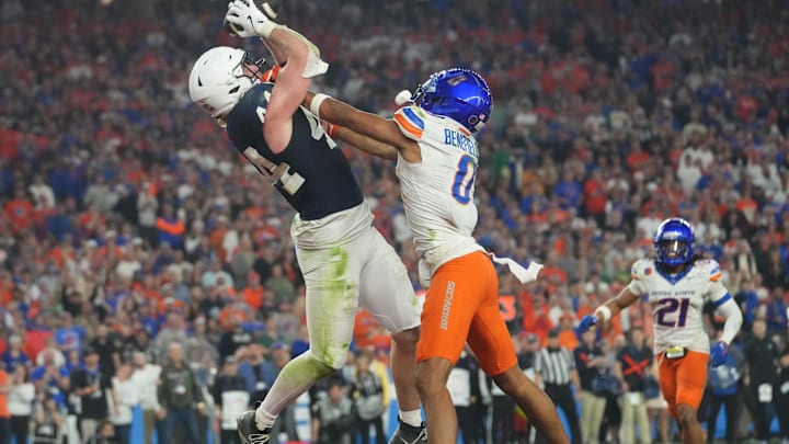 Dec 31, 2024; Glendale, AZ, US; Penn State Nittany Lions tight end Tyler Warren (44) catches a touchdown pass over Boise State Broncos safety Ty Benefield (0) during their Vrbo Fiesta Bowl matchup at State Farm Stadium.
