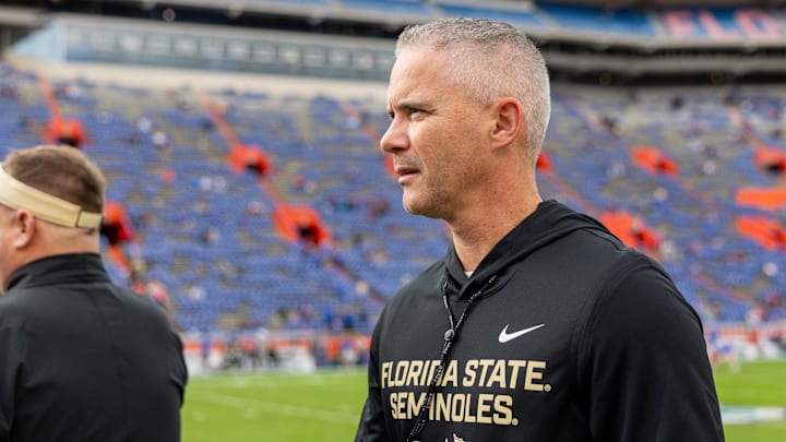 Nov 29, 2025; Gainesville, Florida, USA; Florida State Seminoles head coach Mike Norvell walks the sidelines before a game against the Florida Gators at Ben Hill Griffin Stadium. Mandatory Credit: Bob Kupbens-Imagn Images