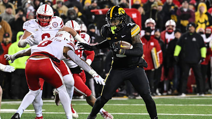 Nov 29, 2024; Iowa City, Iowa, USA; Iowa Hawkeyes running back Kaleb Johnson (2) runs the ball as Nebraska Cornhuskers defensive back DeShon Singleton (8) looks to make the tackle during the third quarter at Kinnick Stadium.