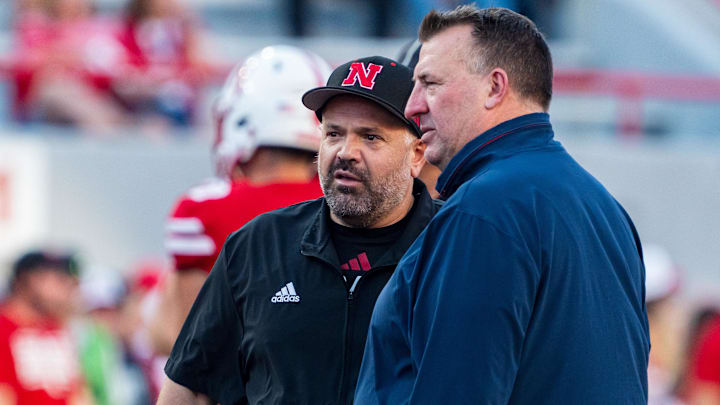 Sep 20, 2024; Lincoln, Nebraska, USA; Nebraska Cornhuskers head coach Matt Rhule and Illinois Fighting Illini head coach Bret Bielema talk before a game at Memorial Stadium. Mandatory Credit: Dylan Widger-Imagn Images