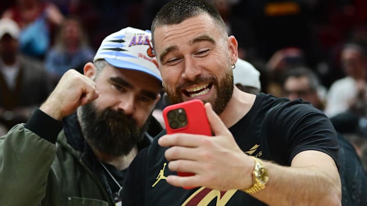 Mar 5, 2024; Cleveland, Ohio, USA; Cleveland natives and NFL players Travis, right, and Jason Kelce celebrate after the Cleveland Cavaliers beat the Boston Celtics during the second half at Rocket Mortgage FieldHouse. Mandatory Credit: Ken Blaze-Imagn Images