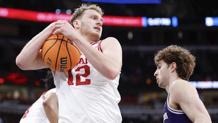 Mar 11, 2026; Chicago, IL, USA; Indiana Hoosiers forward Tucker Devries (12) grabs a rebound against the Northwestern Wildcats during the first half at United Center. Mandatory Credit: Kamil Krzaczynski-Imagn Images