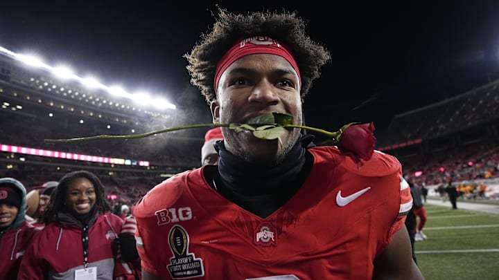 Ohio State Buckeyes safety Caleb Downs leaves the field with a rose in his mouth following the 42-17 win over the Tennessee Volunteers in the College Football Playoff first round game at Ohio Stadium in Columbus on Dec. 21, 2024. Ohio State will face Oregon in the Rose Bowl.