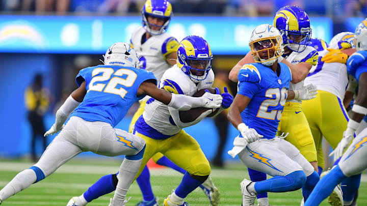 Aug 17, 2024; Inglewood, California, USA; Los Angeles Rams running back Boston Scott (30) runs the ball against Los Angeles Chargers safety JT Woods (22) during the second half at SoFi Stadium. Mandatory Credit: Gary A. Vasquez-Imagn Images