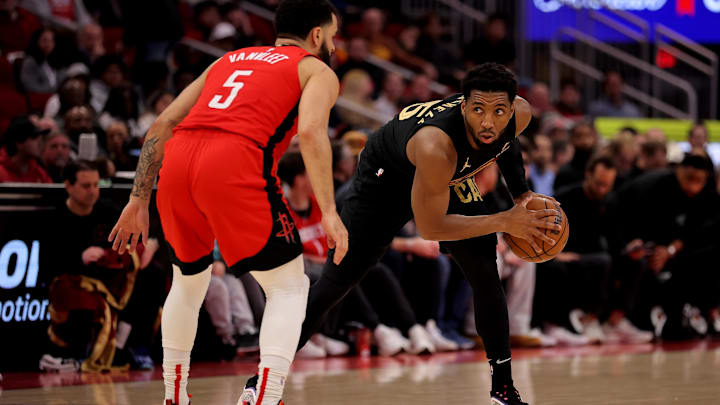 Jan 22, 2025; Houston, Texas, USA; Cleveland Cavaliers guard Donovan Mitchell (45) handles the ball against Houston Rockets guard Fred VanVleet (5) during the first quarter at Toyota Center. Mandatory Credit: Erik Williams-Imagn Images