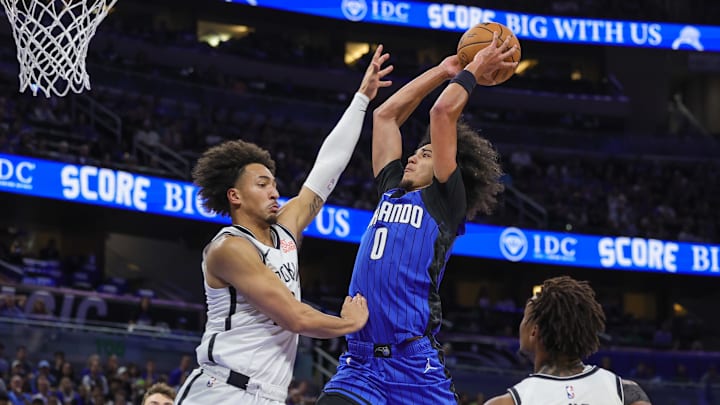 Orlando Magic guard Anthony Black (0) goes to the basket against Brooklyn Nets forward Jalen Wilson (22) during the second half at Kia Center. 