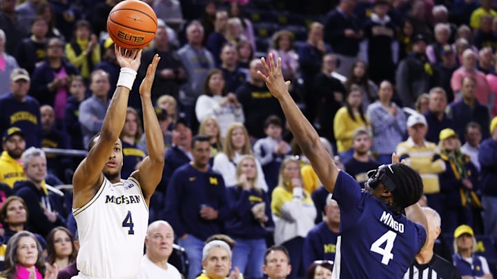 Feb 5, 2026; Ann Arbor, Michigan, USA;  Michigan Wolverines guard Nimari Burnett (4) shoots against Penn State Nittany Lions guard Kayden Mingo (4) in the first half at Crisler Center. Mandatory Credit: Rick Osentoski-Imagn Images