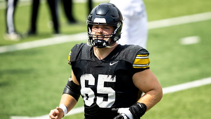 Aug 9, 2025; Iowa offensive lineman Logan Jones (65) warms up during the Hawkeyes Kids Day NCAA football open practice at Kinnick Stadium in Iowa City, Iowa. Mandatory Credit: Joseph Cress for the Des Moines Register
