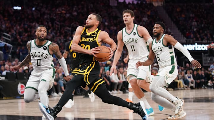 Mar 6, 2024; San Francisco, California, USA; Golden State Warriors guard Stephen Curry (30) drives to the hoop in front of Milwaukee Bucks guard Damian Lillard (0), center Brook Lopez (11), and guard Malik Beasley (5) in the third quarter at the Chase Center. Mandatory Credit: Cary Edmondson-Imagn Images