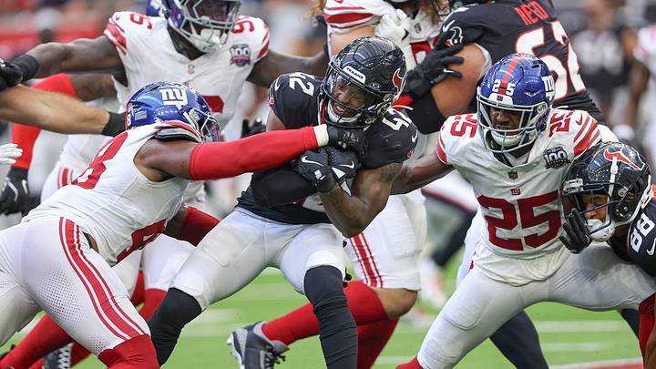 Aug 17, 2024; Houston, Texas, USA; Houston Texans running back Jawhar Jordan (42) runs with the ball as New York Giants linebacker Benton Whitley (48) attempts to make a tackle during the fourth quarter at NRG Stadium. Mandatory Credit: Troy Taormina-USA TODAY Sports