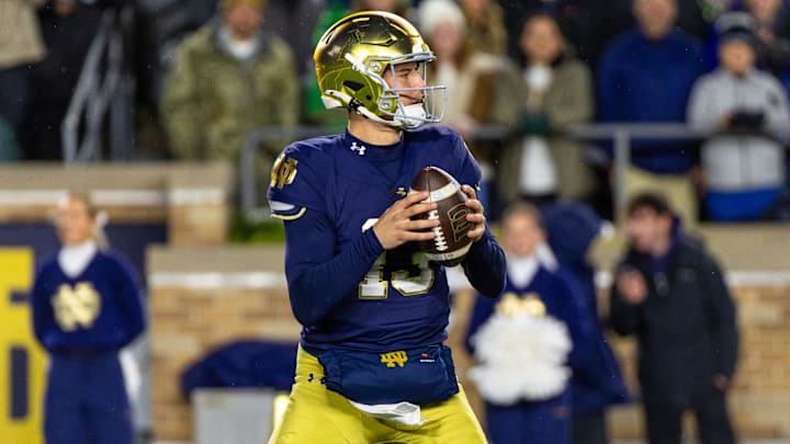Nov 8, 2025; South Bend, Indiana, USA; Notre Dame Fighting Irish quarterback CJ Carr (13) looks to pass against the Navy Midshipmen during the first half at Notre Dame Stadium. Mandatory Credit: Michael Caterina-Imagn Images