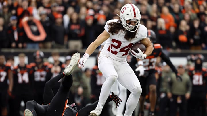 Nov 11, 2023; Corvallis, Oregon, USA; Stanford Cardinal wide receiver Tiger Bachmeier (24) is grabbed by Oregon State Beavers defensive back Akili Arnold (0) during the first half at Reser Stadium. Mandatory Credit: Soobum Im-Imagn Images