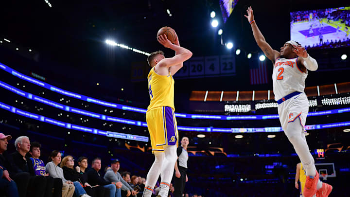 Mar 6, 2025; Los Angeles, California, USA; Los Angeles Lakers guard Dalton Knecht (4) shoots three point basket against New York Knicks guard Miles McBride (2) during the second half at Crypto.com Arena. Mandatory Credit: Gary A. Vasquez-Imagn Images