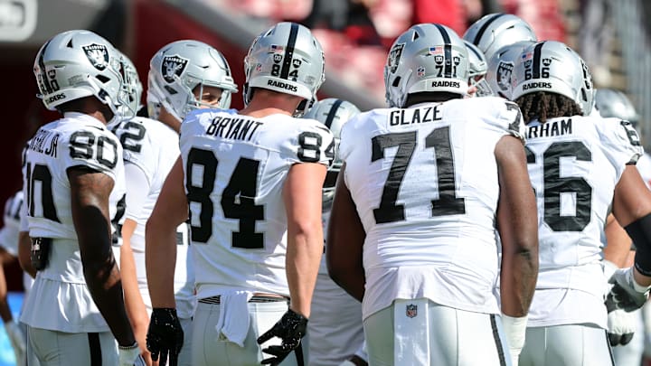 Dec 8, 2024; Tampa, Florida, USA; Las Vegas Raiders quarterback Aidan O'Connell (12) and teammates huddle up before the game against the Tampa Bay Buccaneers at Raymond James Stadium. Mandatory Credit: Kim Klement Neitzel-Imagn Images