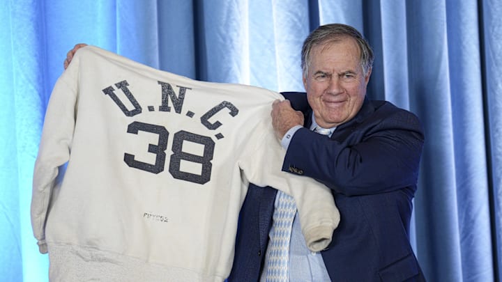 North Carolina Tar Heels coach Bill Belichick holds up the sweatshirt worn by his father when he was an assistant coach. North Carolina Tar Heels coach Bill Belichick holds up the sweatshirt worn by his father when he was an assistant coach.