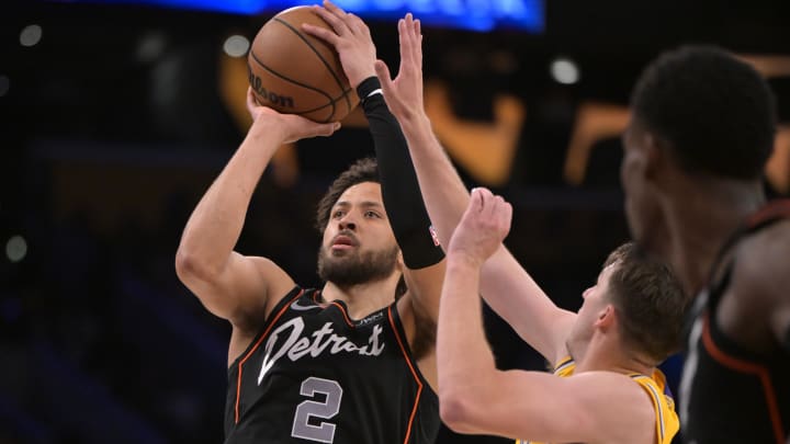 Feb 13, 2024; Los Angeles, California, USA; Detroit Pistons guard Cade Cunningham (2) shoots past Los Angeles Lakers guard Austin Reaves (15) in the second half at Crypto.com Arena. Mandatory Credit: Jayne Kamin-Oncea-USA TODAY Sports