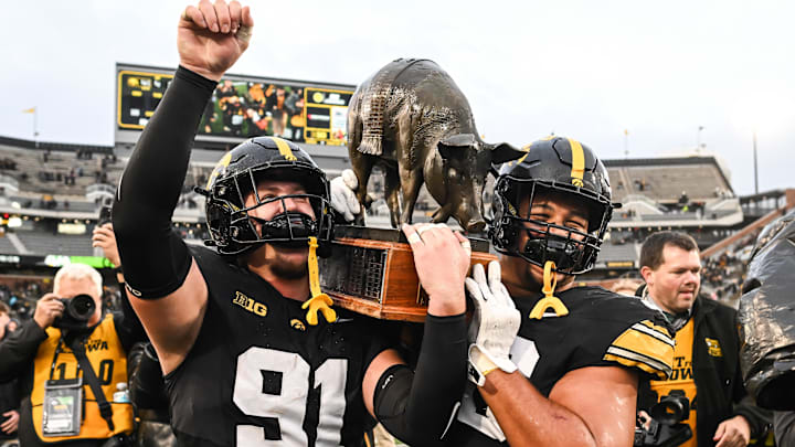 Oct 25, 2025; Iowa City, Iowa, USA; Iowa Hawkeyes defensive lineman Jonah Pace (91) and defensive lineman Bryce Hawthorne (96) carry off the Floyd of Rosedale trophy after their victory over the Minnesota Golden Gophers at Kinnick Stadium. Oct 25, 2025; Iowa City, Iowa, USA; Iowa Hawkeyes defensive lineman Jonah Pace (91) and defensive lineman Bryce Hawthorne (96) carry off the Floyd of Rosedale trophy after their victory over the Minnesota Golden Gophers at Kinnick Stadium.