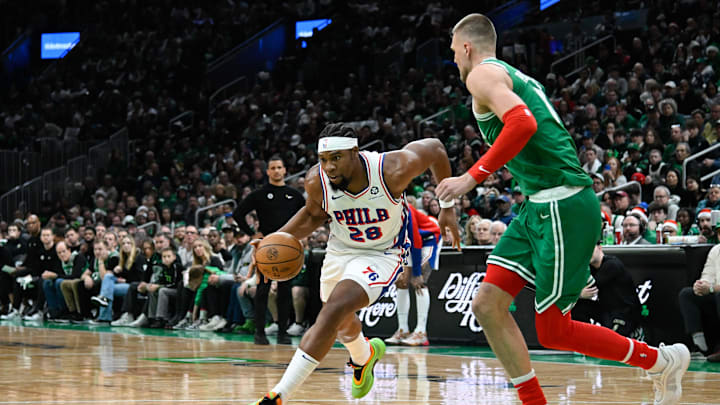 Dec 25, 2024; Boston, Massachusetts, USA; Philadelphia 76ers forward Guerschon Yabusele (28) drives the to basket against Boston Celtics center Kristaps Porzingis (8) during the first half at TD Garden. Mandatory Credit: Eric Canha-Imagn Images