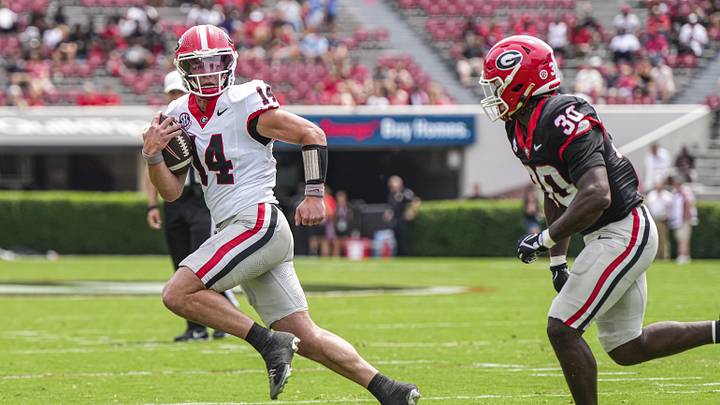 Apr 18, 2026; Athens, GA, USA; Georgia Bulldogs quarterback Gunner Stockton (14) runs against linebacker Terrell Foster (30) during the Georgia Spring football game at Sanford Stadium. Mandatory Credit: Dale Zanine-Imagn Images Apr 18, 2026; Athens, GA, USA; Georgia Bulldogs quarterback Gunner Stockton (14) runs against linebacker Terrell Foster (30) during the Georgia Spring football game at Sanford Stadium. Mandatory Credit: Dale Zanine-Imagn Images