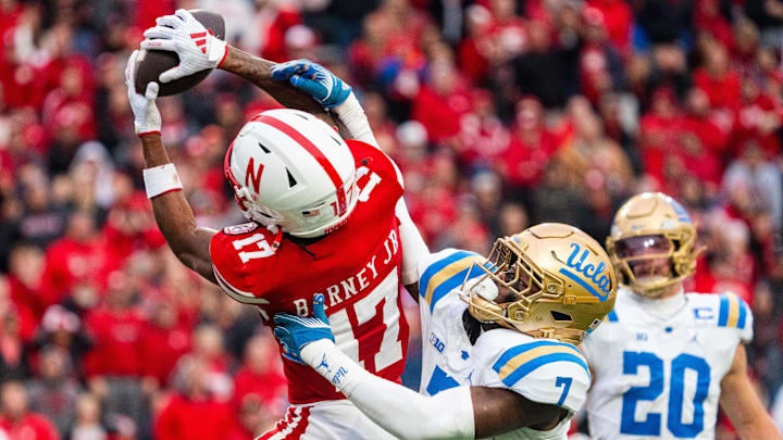 Nov 2, 2024; Lincoln, Nebraska, USA; Nebraska Cornhuskers wide receiver Jacory Barney Jr. (17) makes a catch against UCLA Bruins defensive back K.J. Wallace (7) during the third quarter at Memorial Stadium. Mandatory Credit: Dylan Widger-Imagn Images