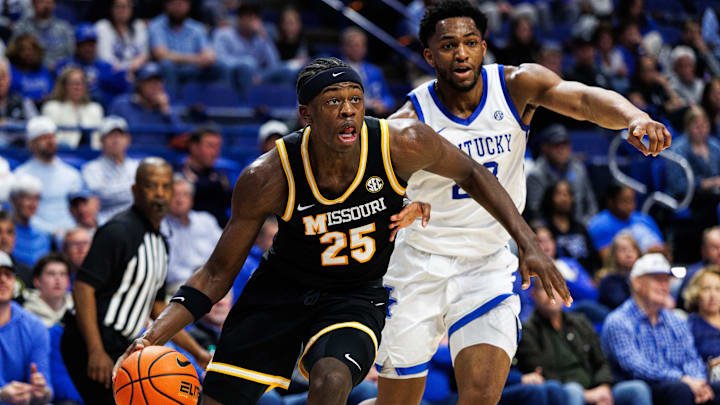 Jan 7, 2026; Lexington, Kentucky, USA; Missouri Tigers forward Mark Mitchell (25) drives to the basket around Kentucky Wildcats forward Mouhamed Dioubate (23) during the first half at Rupp Arena at Central Bank Center. 