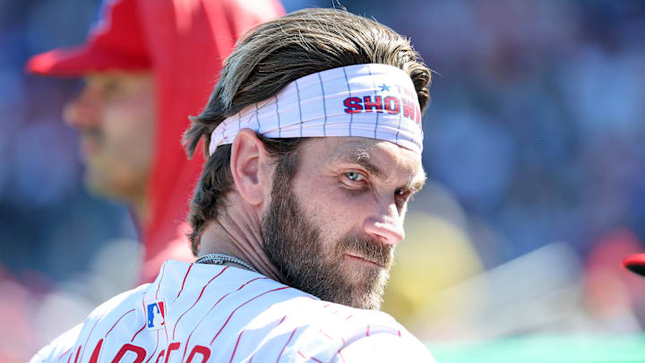 Feb 28, 2025; Clearwater, Florida, USA; Philadelphia Phillies first base Bryce Harper (3) looks on in the dugout against the Boston Red Sox at BayCare Ballpark. Feb 28, 2025; Clearwater, Florida, USA; Philadelphia Phillies first base Bryce Harper (3) looks on in the dugout against the Boston Red Sox at BayCare Ballpark.