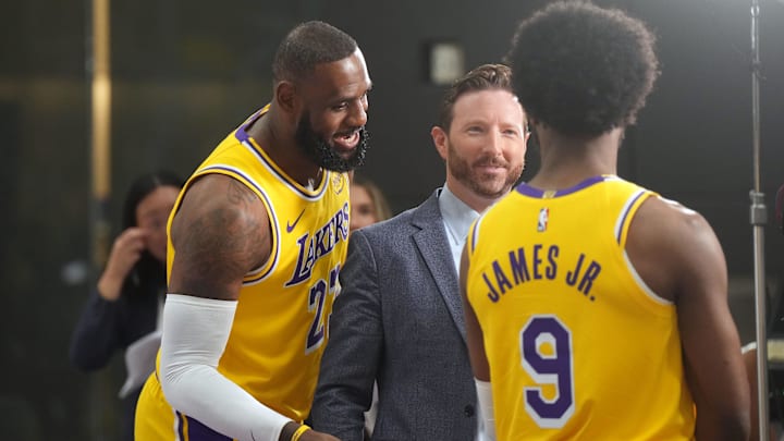 Sep 30, 2024; El Segundo, CA, USA; Los Angeles Lakers forward LeBron James (23) watches as ESPN reporter Dave McMenamin, (center) interviews son Bronny James (9) during media day at the UCLA Health Training Center. Mandatory Credit: Kirby Lee-Imagn Images Sep 30, 2024; El Segundo, CA, USA; Los Angeles Lakers forward LeBron James (23) watches as ESPN reporter Dave McMenamin, (center) interviews son Bronny James (9) during media day at the UCLA Health Training Center. Mandatory Credit: Kirby Lee-Imagn Images