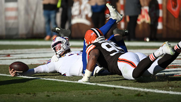 Buffalo Bills quarterback Josh Allen (17) is sacked by Cleveland Browns defensive tackle Mason Graham (94) and defensive end Myles Garrett (95) during the first half at Huntington Bank Field.