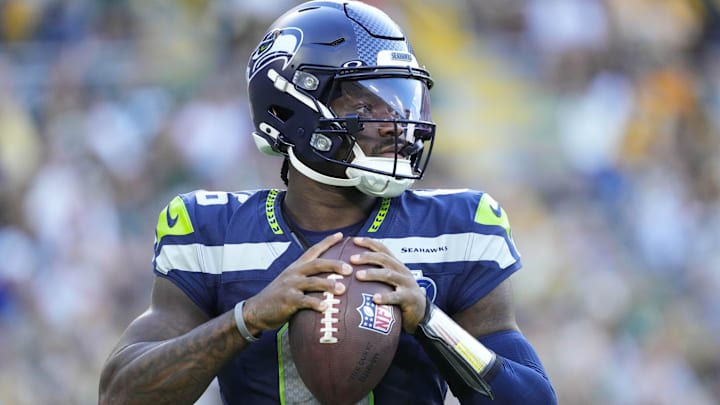 Seattle Seahawks QB Jalen Milroe warms up near the sidelines during the game against the Green Bay Packers.