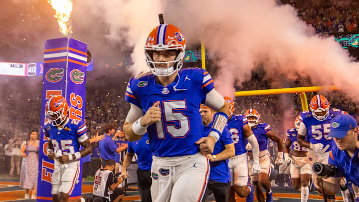 Florida Gators quarterback Graham Mertz (15) runs out of the tunnel with the team as fireworks and fire shoot out of towers before the start of the game at Ben Hill Griffin Stadium in Gainesville, FL on Saturday, October 5, 2024