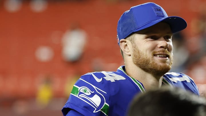 Nov 2, 2025; Landover, Maryland, USA; Seattle Seahawks quarterback Sam Darnold (14) smiles while leaving the field after the game against the Washington Commanders at Northwest Stadium. 