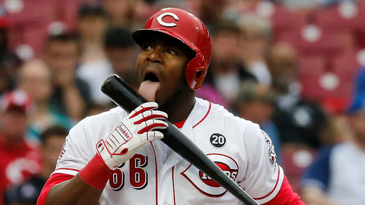 Cincinnati Reds right fielder Yasiel Puig (66) licks his bat after swinging for strike two.