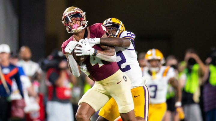 Florida State Seminoles wide receiver Keon Coleman (4) catches a pass from Florida State Seminoles quarterback Jordan Travis (13) during a game against the LSU Tigers at Camping World Stadium on Sunday, Sept. 3, 2023.