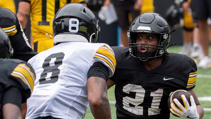 Iowa running back L.J. Phillips Jr. (21) carries the ball as Iowa defensive back Deshaun Lee (8) defends Aug. 15, 2026 during the Kids Day at Kinnick open practice at Kinnick Stadium in Iowa City, Iowa.