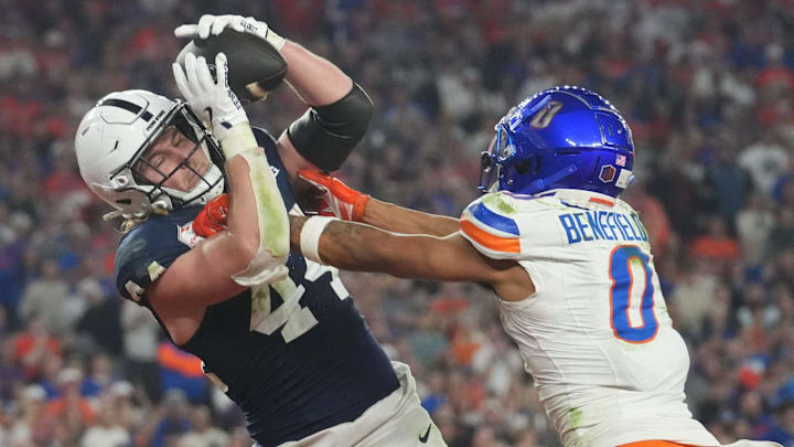 Penn State Nittany Lions tight end Tyler Warren (44) catches a touchdown pass over Boise State Broncos safety Ty Benefield (0) during their Vrbo Fiesta Bowl matchup at State Farm Stadium.