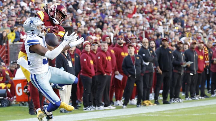 Washington Commanders wide receiver Noah Brown attempts to Catcha pass as Dallas Cowboys cornerback Josh Butler defends.
