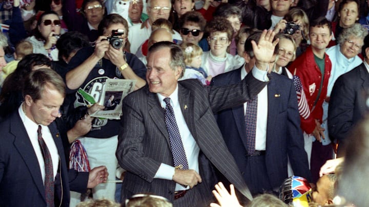 President George HW Bush waves during a campaign rally in Washington Township, NJ, on October 22, 1992. 