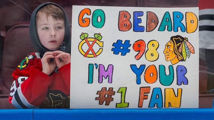 Mar 15, 2025; Vancouver, British Columbia, CAN; A young fan holds up a sign for Chicago Blackhawks forward Connor Bedard (98) during warm up prior to a game against the Vancouver Canucks at Rogers Arena. Mandatory Credit: Bob Frid-Imagn Images