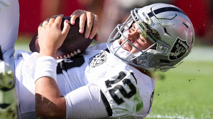 Dec 8, 2024; Tampa, Florida, USA; Las Vegas Raiders quarterback Aidan O'Connell (12) is sacked by Tampa Bay Buccaneers linebacker Lavonte David (54) in the first quarter at Raymond James Stadium. Mandatory Credit: Nathan Ray Seebeck-Imagn Images