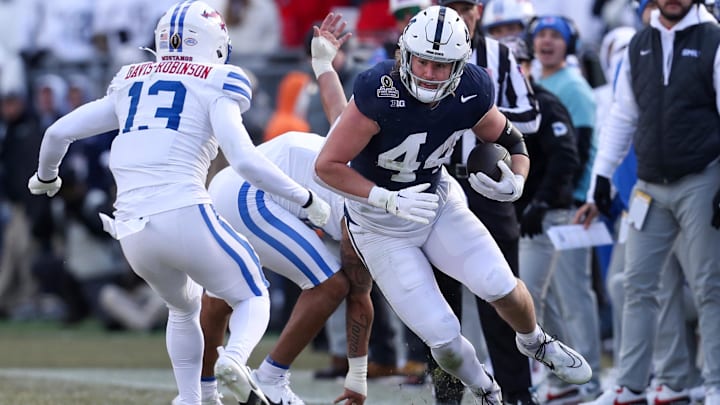Dec 21, 2024; University Park, Pennsylvania, USA; Penn State Nittany Lions tight end Tyler Warren (44) runs with the ball while trying to avoid a tackle during the second quarter against the Southern Methodist Mustangs in the first round of the College Football Playoff at Beaver Stadium. Mandatory Credit: Matthew O'Haren-Imagn Images