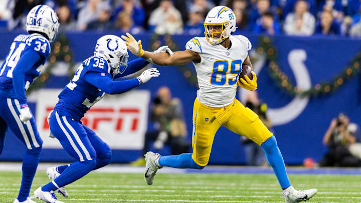 Dec 26, 2022; Indianapolis, Indiana, USA;  Los Angeles Chargers tight end Donald Parham Jr. (89) runs with the ball while Indianapolis Colts safety Julian Blackmon (32) defends in the first half at Lucas Oil Stadium. 