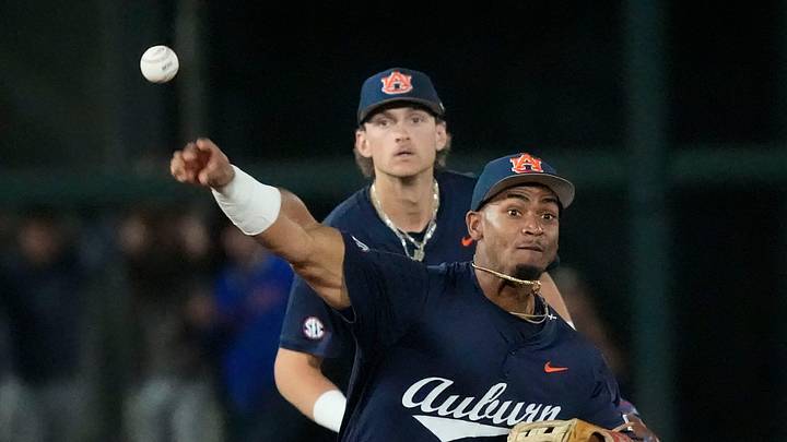 March 28, 2026; Tuscaloosa, AL, USA; Auburn second baseman Chris Rembert fields and throws to first for an out during the game with Alabama at Sewell-Thomas Stadium.