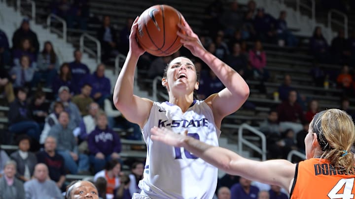 Jan 8, 2014; Manhattan, KS, USA; Kansas State Wildcats guard Leticia Romero (10) drives to the basket past Oklahoma State Cowgirls guard Roshunda Johnson (00) during the second half at Fred Bramlage Coliseum. Oklahoma State won 58-51. Mandatory Credit: Peter G. Aiken-USA TODAY Sports