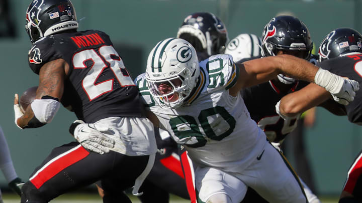 Green Bay Packers defensive end Lukas Van Ness (90) tackles Houston Texans running back Joe Mixon. Green Bay Packers defensive end Lukas Van Ness (90) tackles Houston Texans running back Joe Mixon.